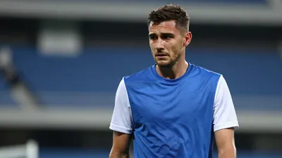 Mid-30s Dinamo Zagreb midfielder, lean build, shoulders hunched, head turned slightly left, eyes glazed with...