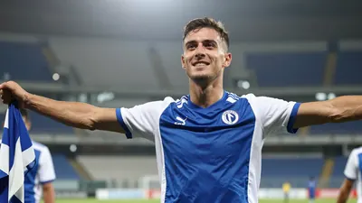 A close-up of a 25-year-old, 5'11" midfielder, with a lean athletic build, celebrating his first goal of the season, his...