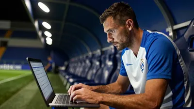 A 22-year-old Dinamo Zagreb scout, a lean, rugged man in his late 40s with a strong jawline, closely examines a player...