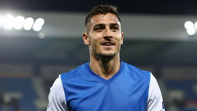 Mid-30s, muscular Dinamo Zagreb midfielder, head-and-shoulders, eyes shining with triumph, short dark hair, slight stubble