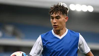 A photorealistic image of a young, athletic-looking player with a messy, short haircut, wearing a blue and white jersey...