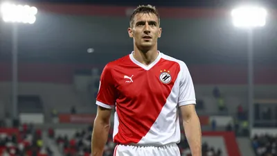A photorealistic image of an anonymous Dinamo Zagreb player, aged 25-30, wearing a red and white jersey with a white...