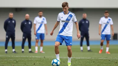 A tight waist-up shot of a young, athletic-looking Dinamo Zagreb centre-forward, wearing a white jersey with a blue...