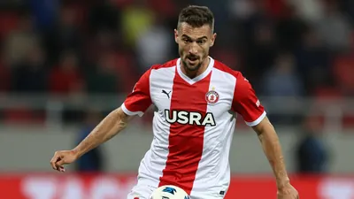 A photorealistic image of a Dinamo Zagreb player, Smail Prevljak, in action, wearing a red and white jersey, with a white...