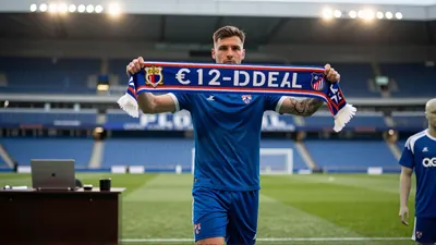 Sergi Domínguez sprinting down a rain-slick pitch, wearing a plain red jersey and black shorts with no visible badges...